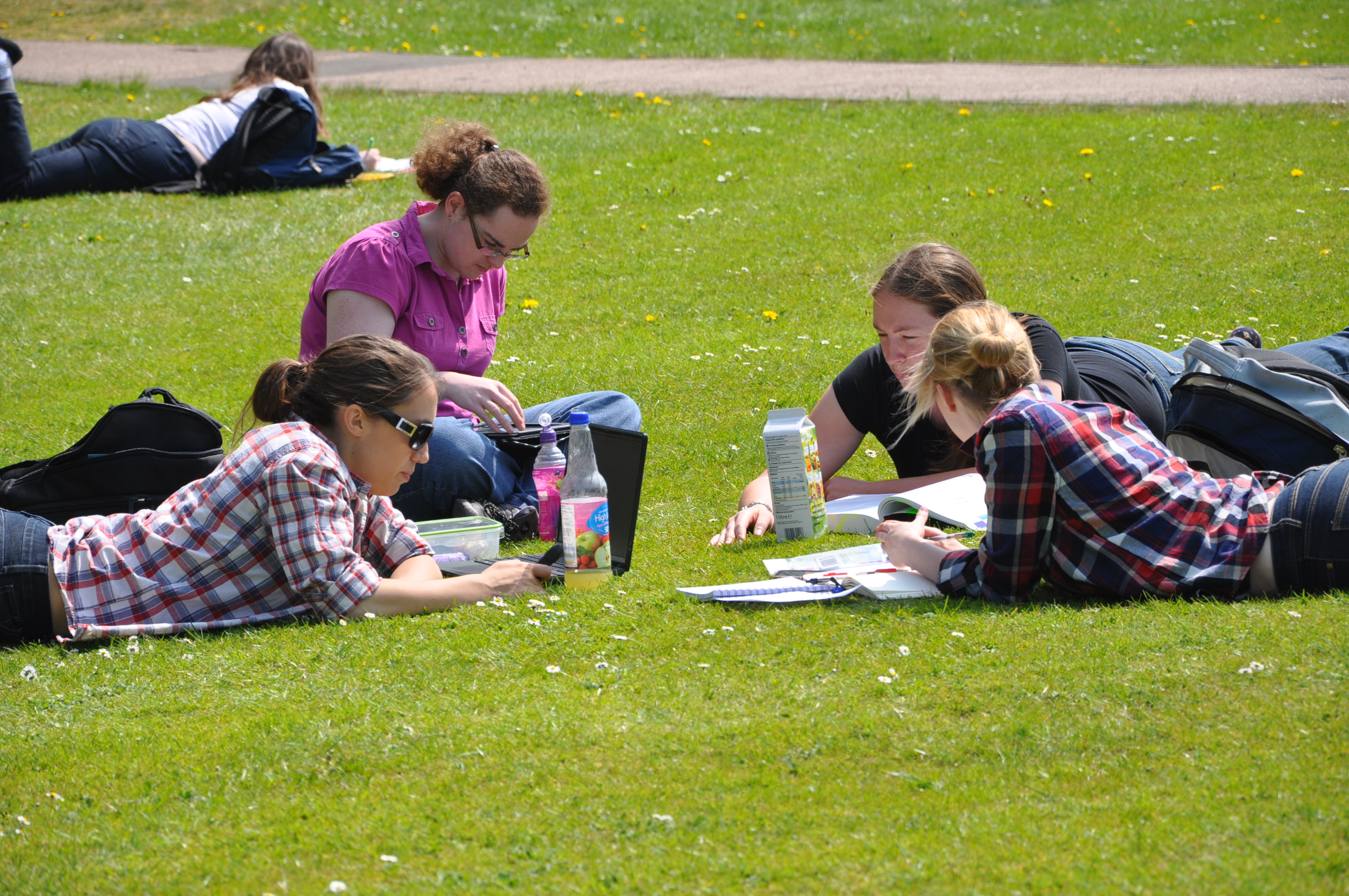 students relaxing on the lawns at Hawkshead