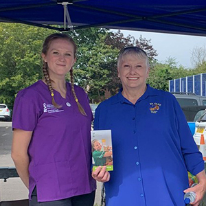 two fundraisers at a stand