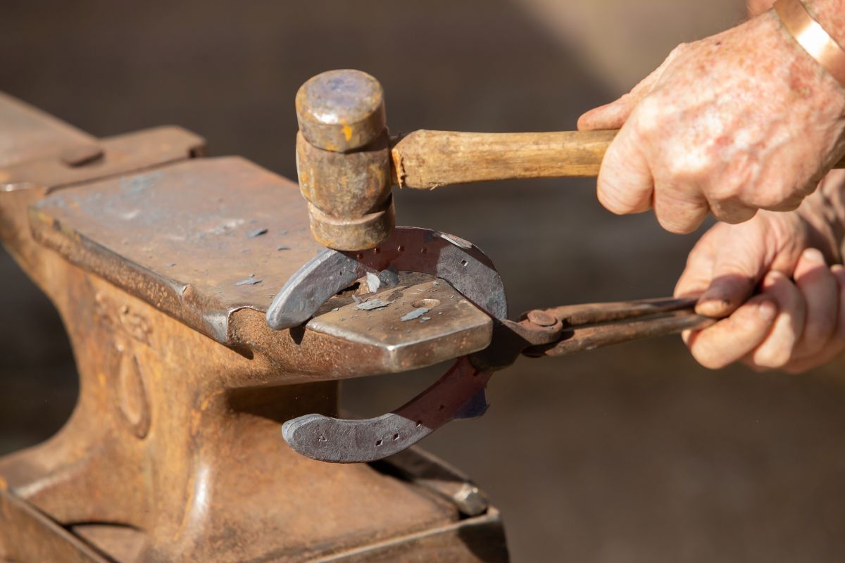 Farrier close up of horseshow on anvil