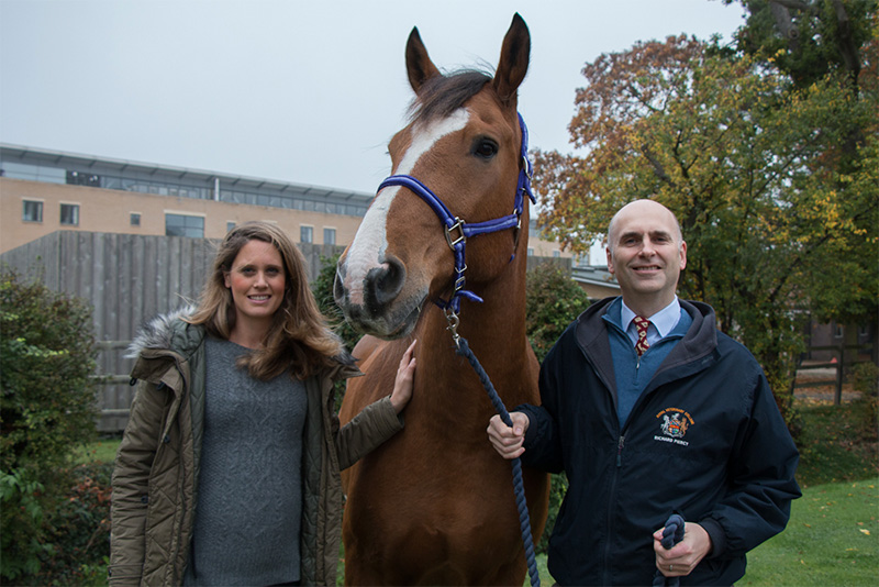 Charloote and Richard standing either side of a horse