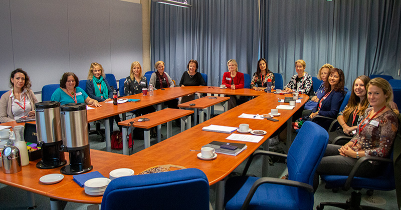 Several RVC female staff members seated round a meeting table