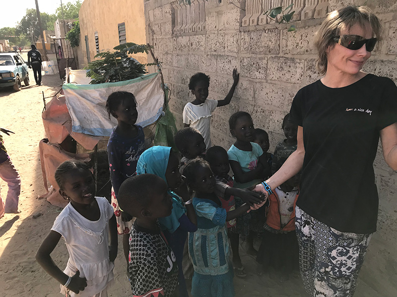 Professor Joanne Webster with children on a street in Africa