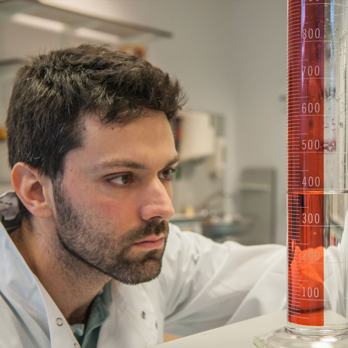 Student looking at a measuring beaker